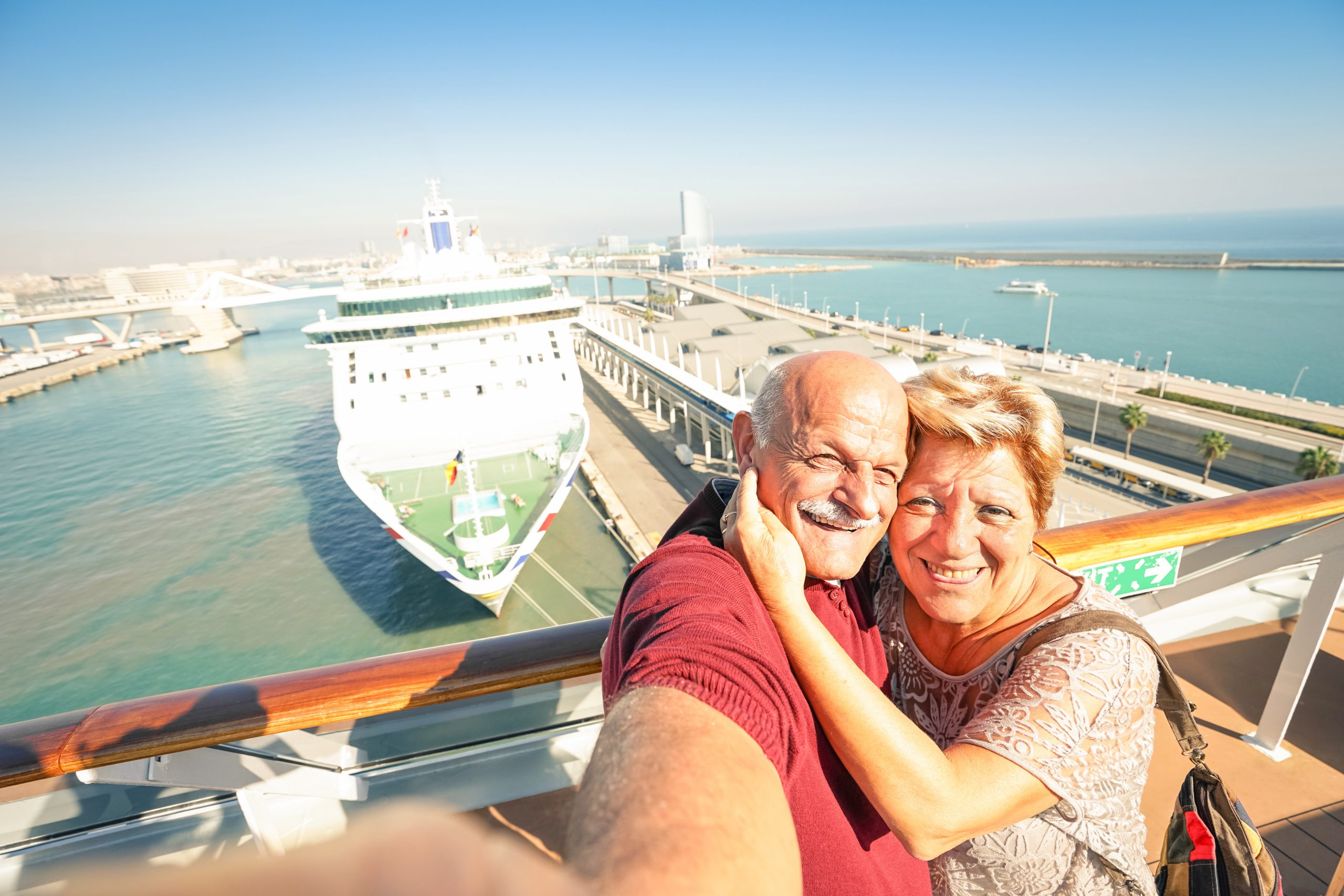 Senior happy couple taking selfie on cruise ship travel at Barcelona harbour - Active retired people having fun